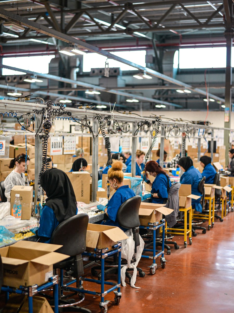 Workers in blue uniforms on an assembly line