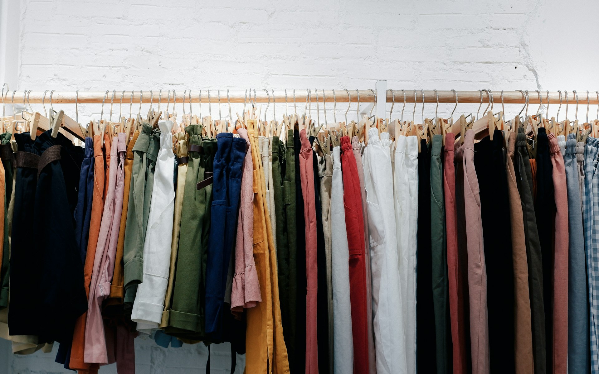 Garments displayed on a wooden wall rack
